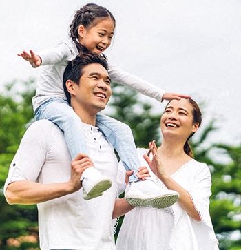 a man and woman with a child on their shoulders